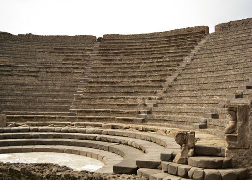 Free Ancient Roman amphitheater ruins showcasing stone seating under daylight. Stock Photo