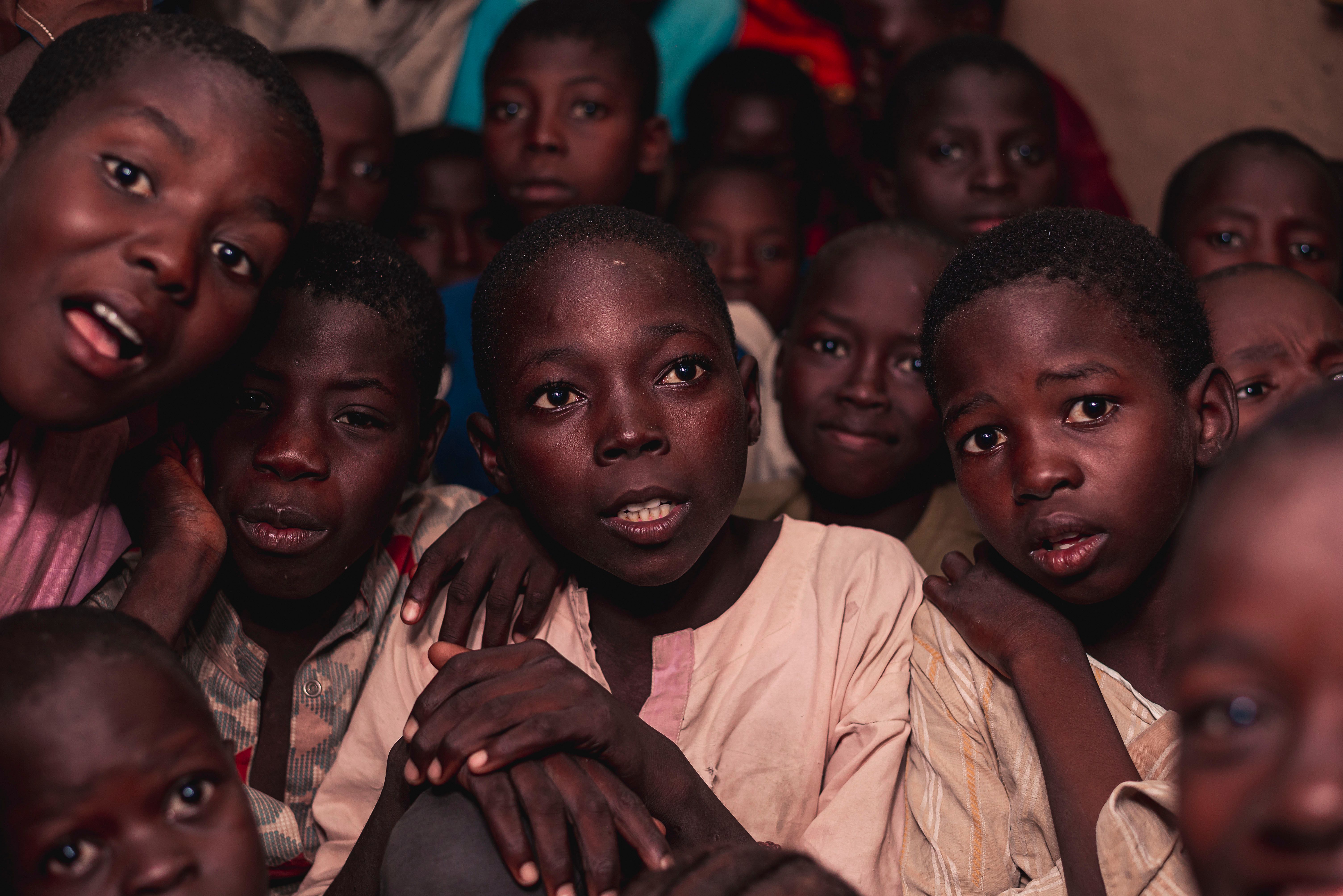 Nigerian children gathered together in a community setting