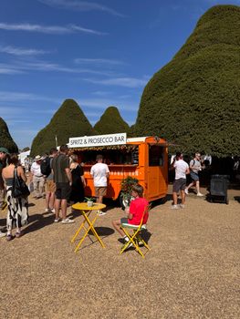 Lively summer scene at a spritz and prosecco bar in Molesey, England.