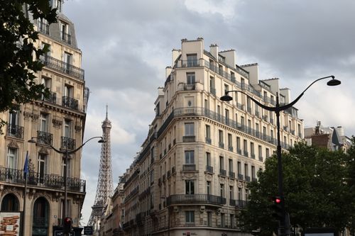 Free Charming urban scene of Paris street with iconic Eiffel Tower in the background. Stock Photo