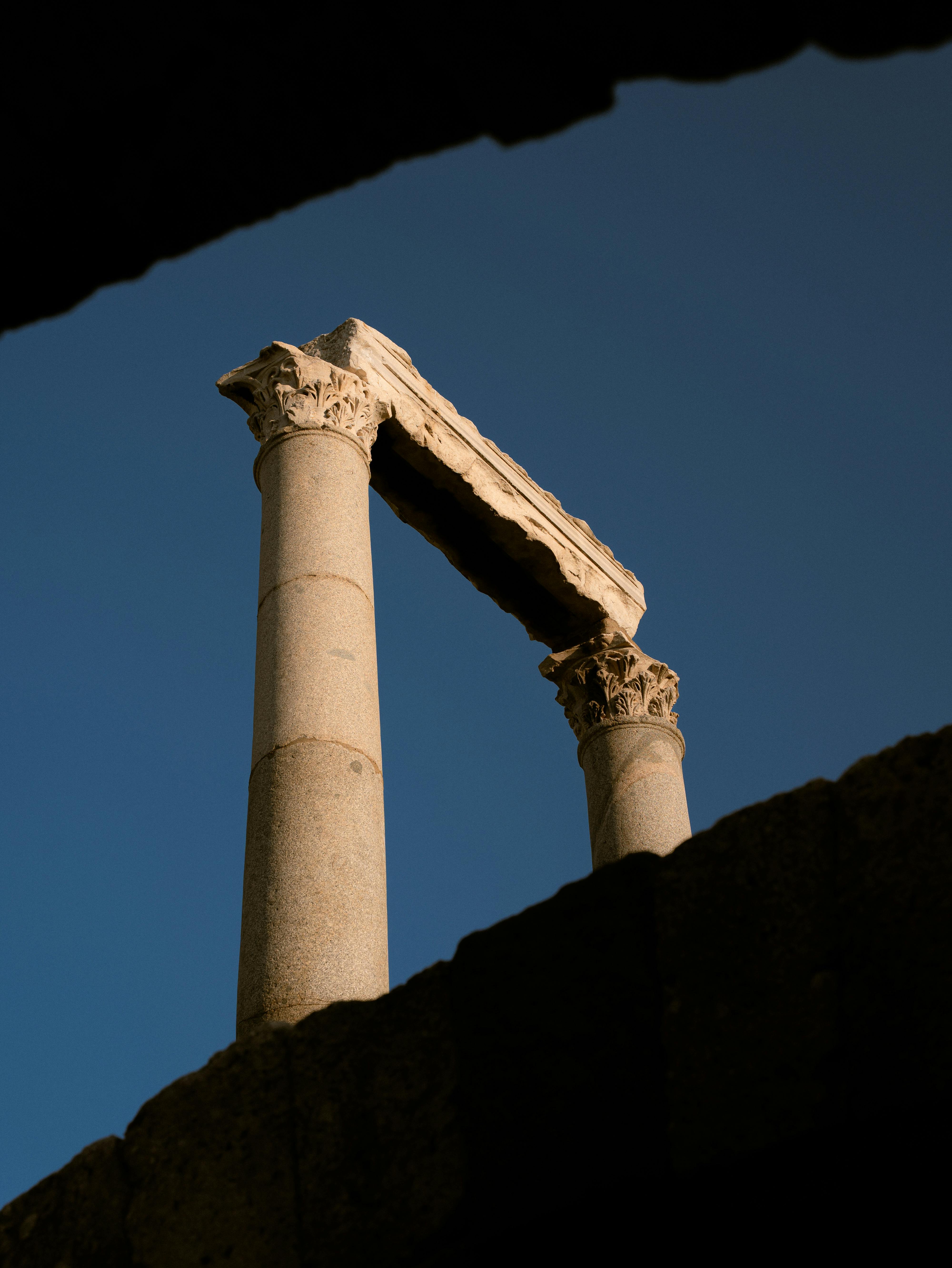 Dramatic view of ancient Roman columns silhouetted against a twilight sky in İzmir.