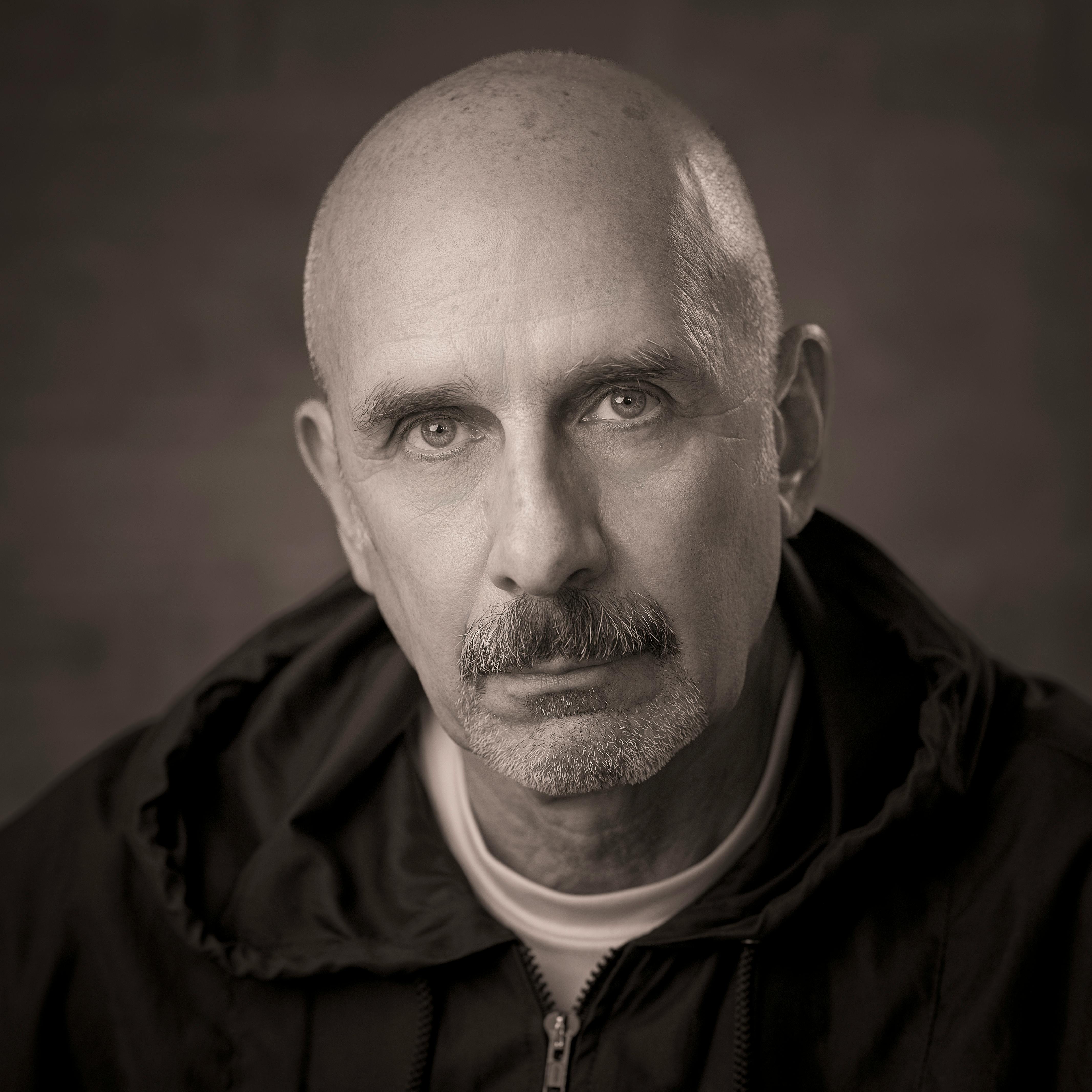 A bald man in black and white