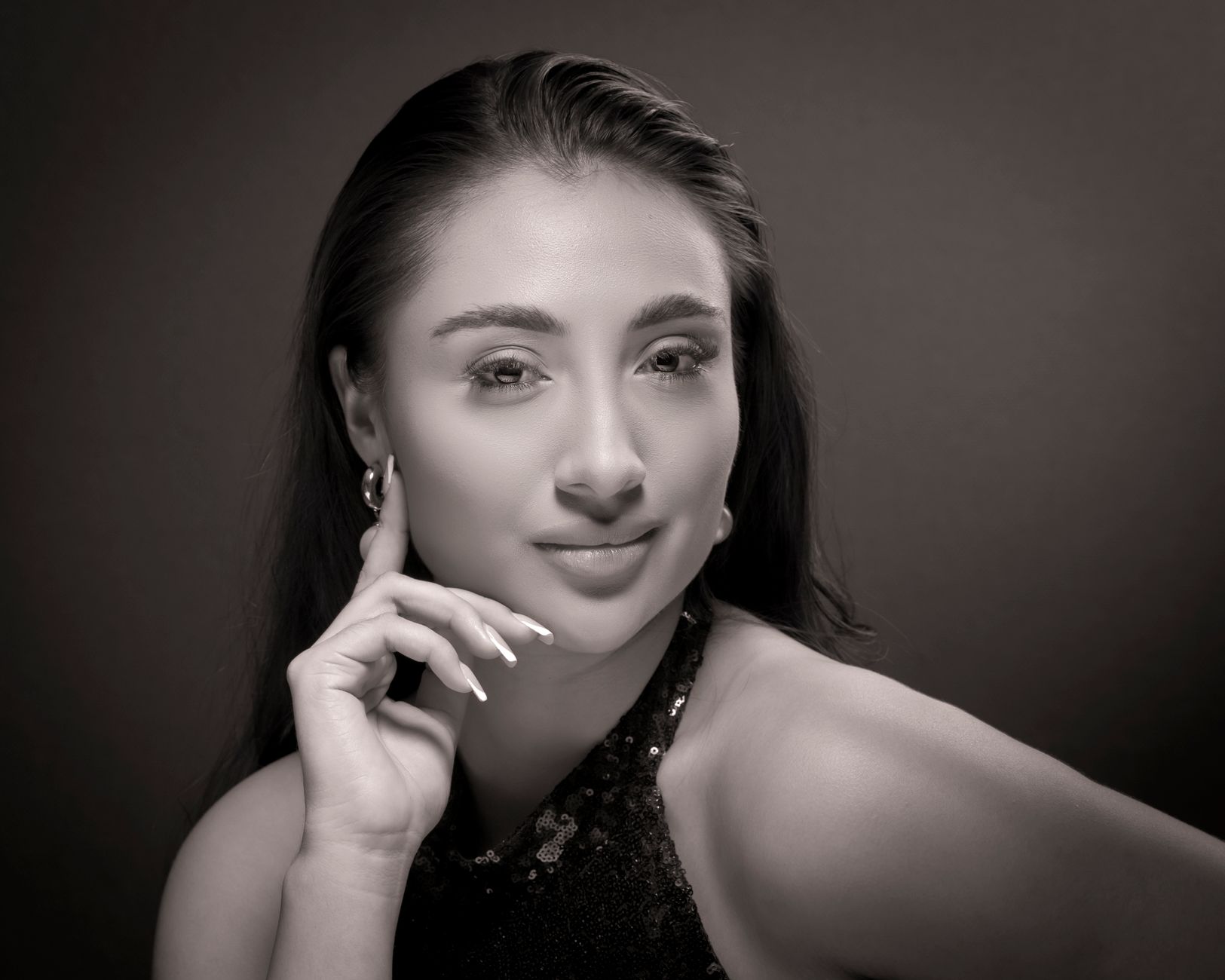 A sophisticated black and white portrait highlighting a woman's elegance and grace.