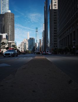 Street view of downtown Chicago showcasing skyscrapers under a clear blue sky.