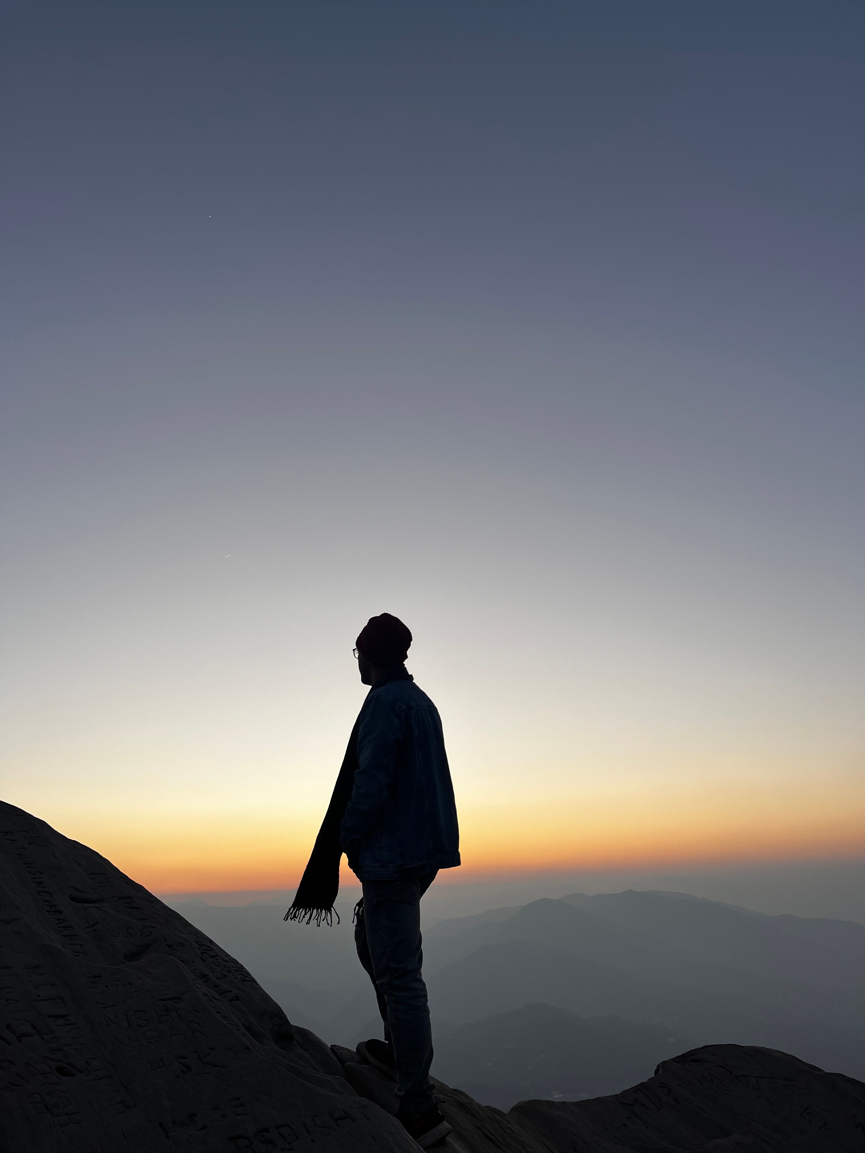 Silhouette of person on mountain at twilight, offering a calming view of the fading sunset over distant peaks.. pexels, silho