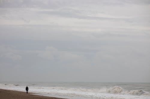 Man Standing Near the Shoreline