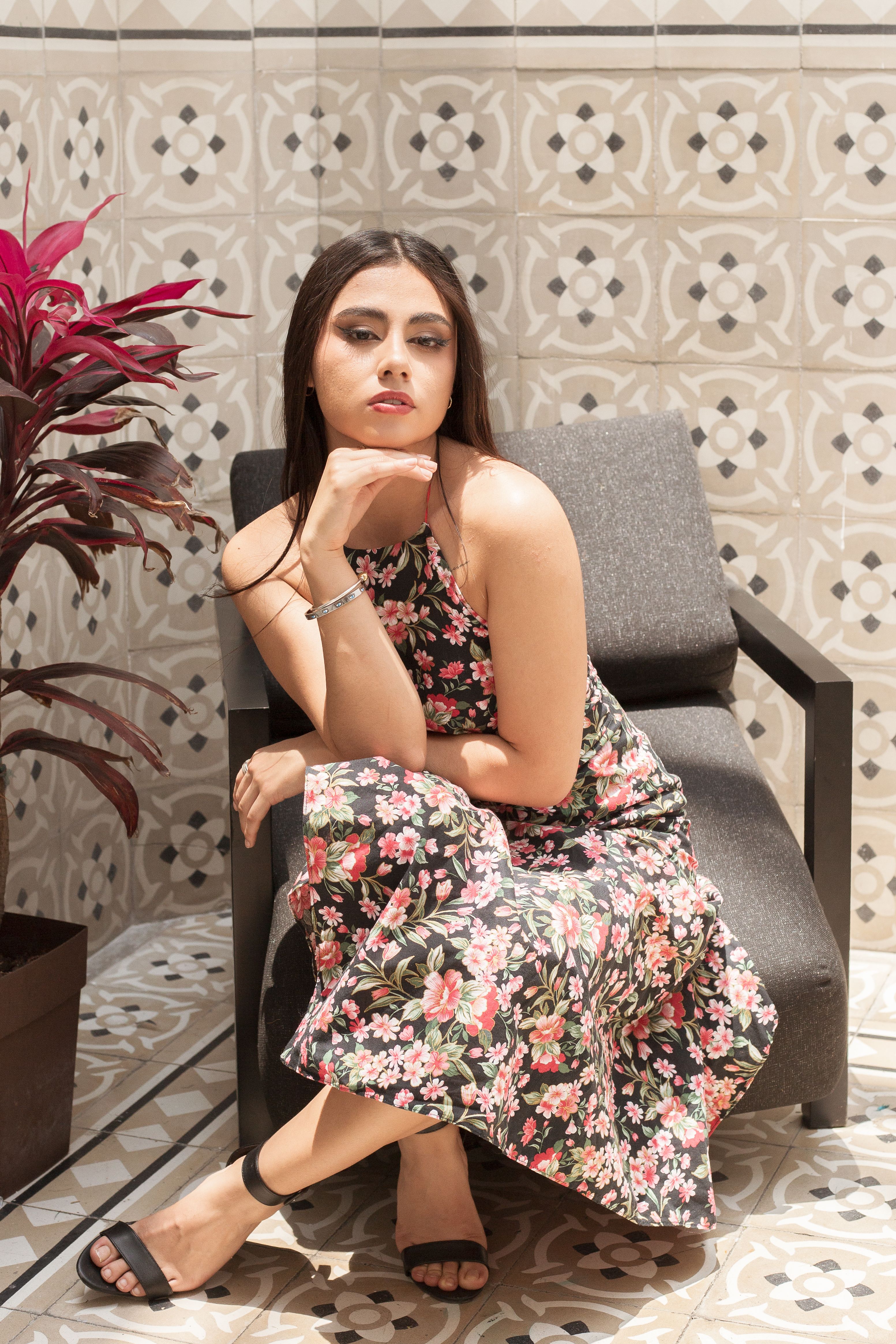 Elegant Woman in Floral Dress Relaxing Indoors · Free Stock Photo