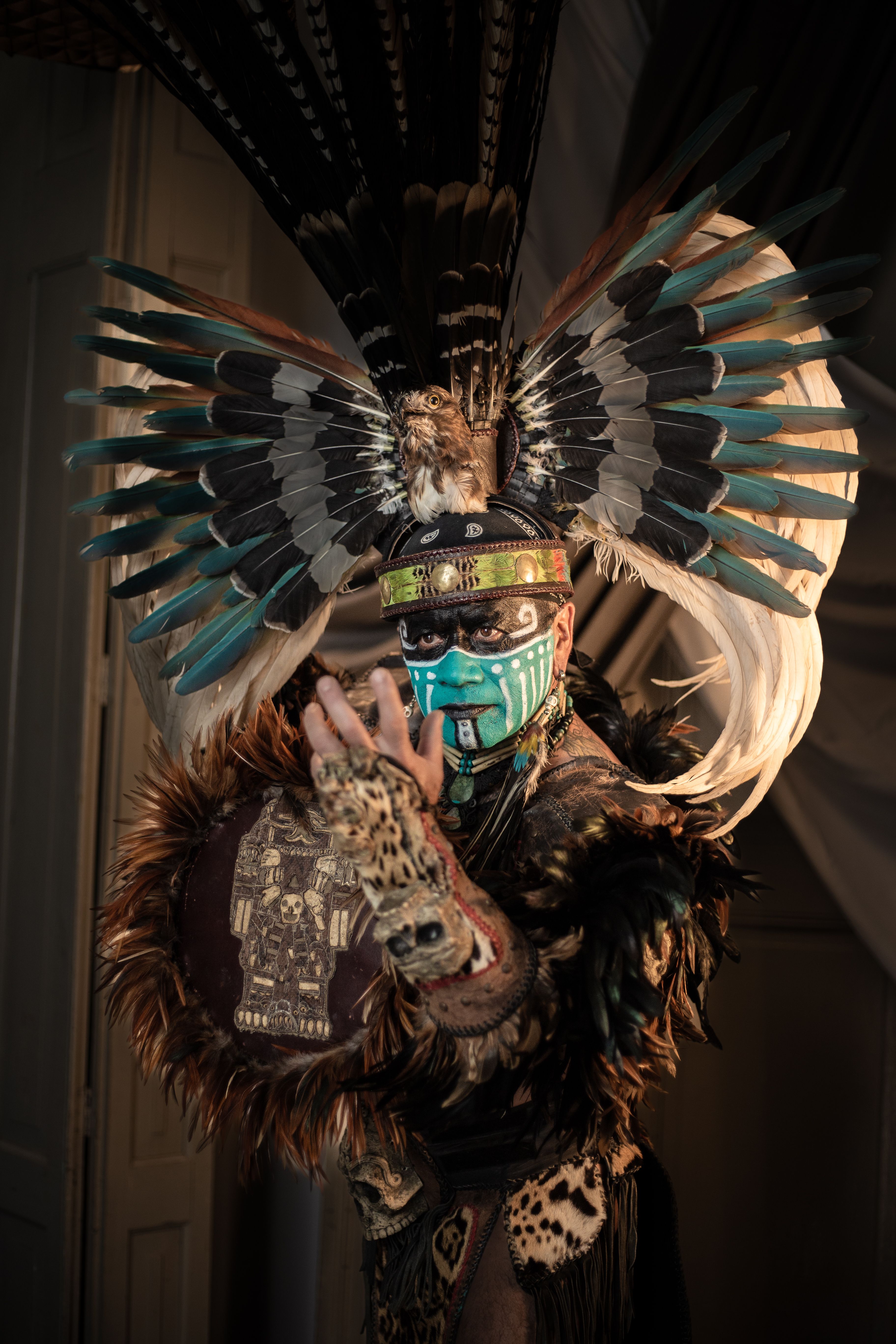 Intricate portrait of an Aztec warrior in traditional jaguar costume with feathered headdress.