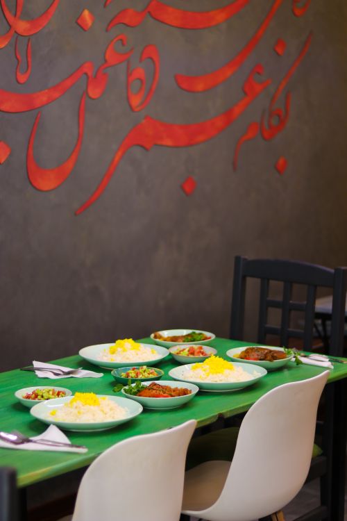 Free Colorful Middle Eastern dining setup with traditional dishes on a green table. Stock Photo