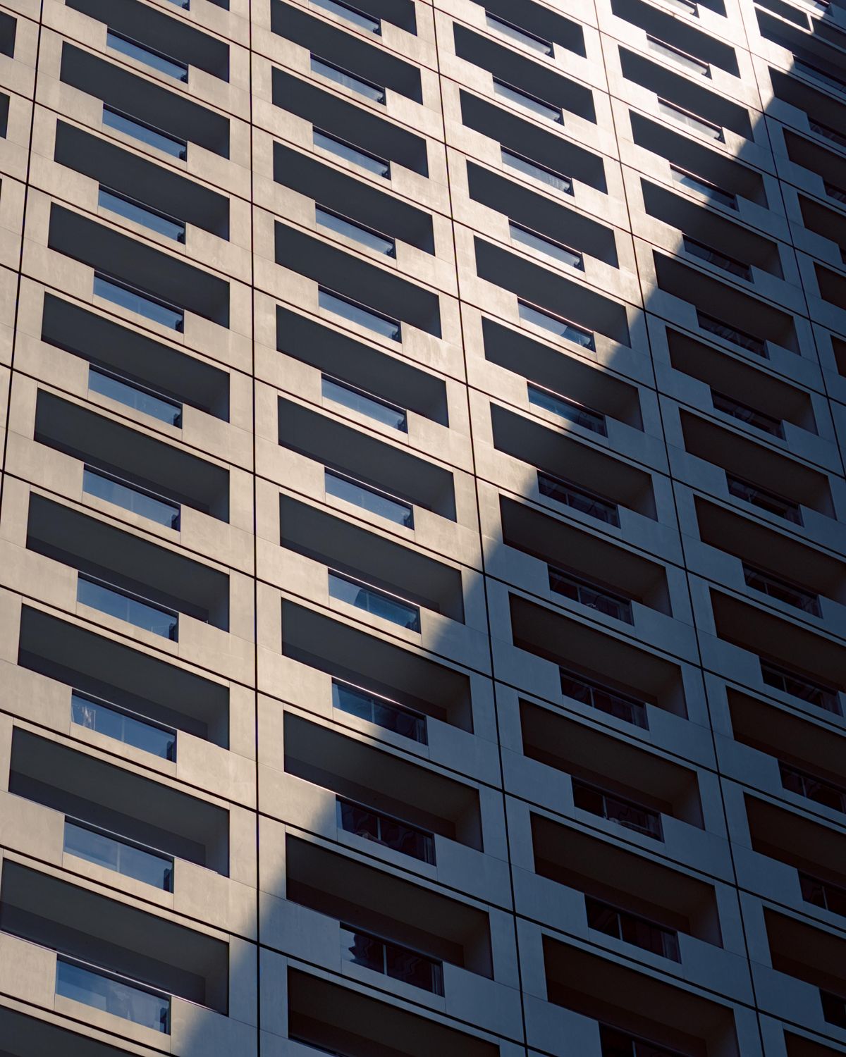 Shadowed Facade of Urban High-Rise Building · Free Stock Photo