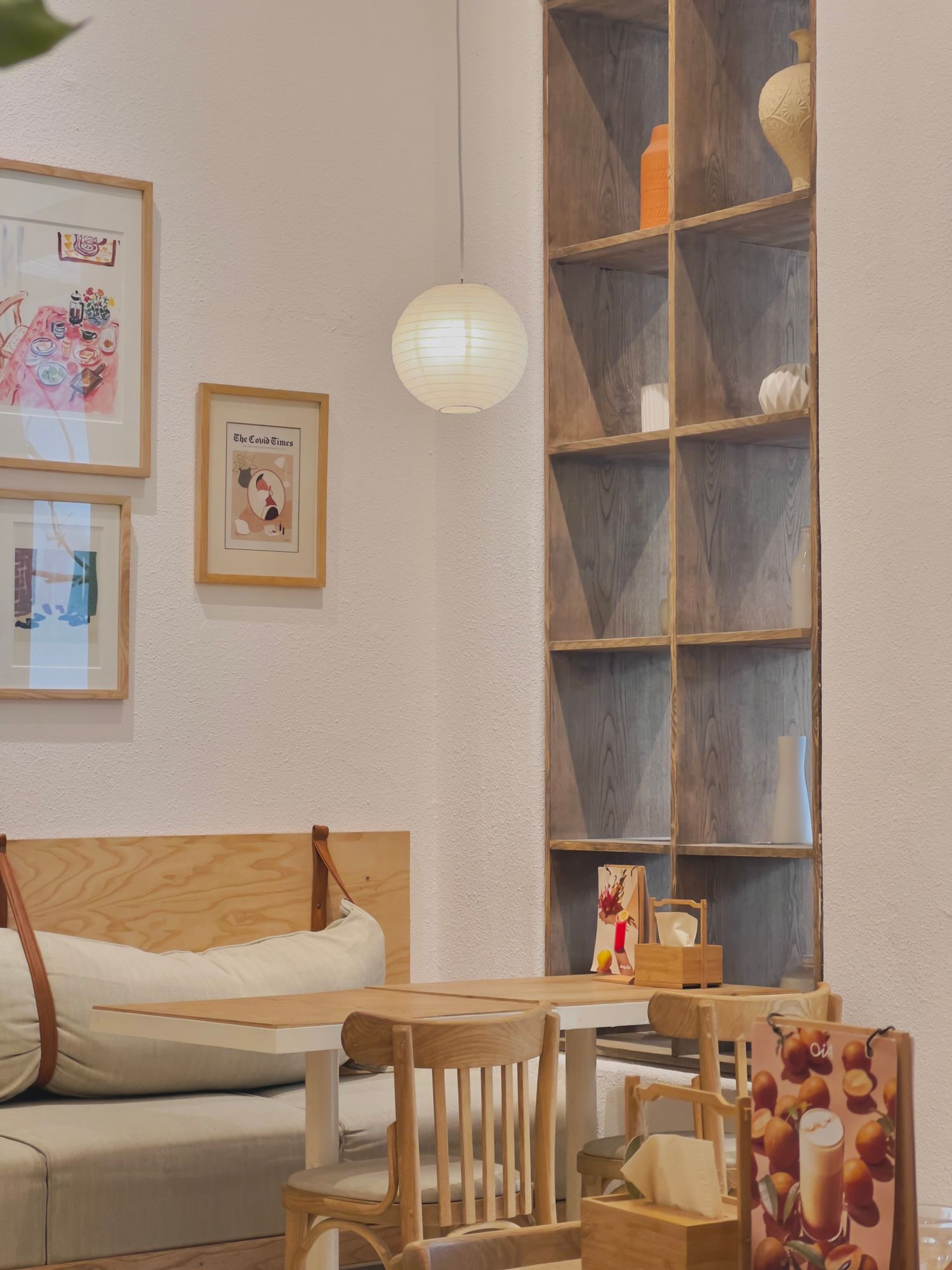 Small café interior with timber seating and framed artwork