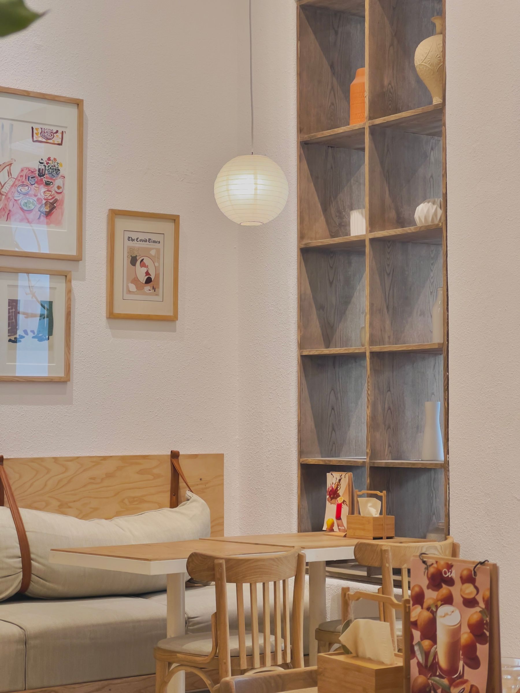 Small café interior with timber seating and framed artwork