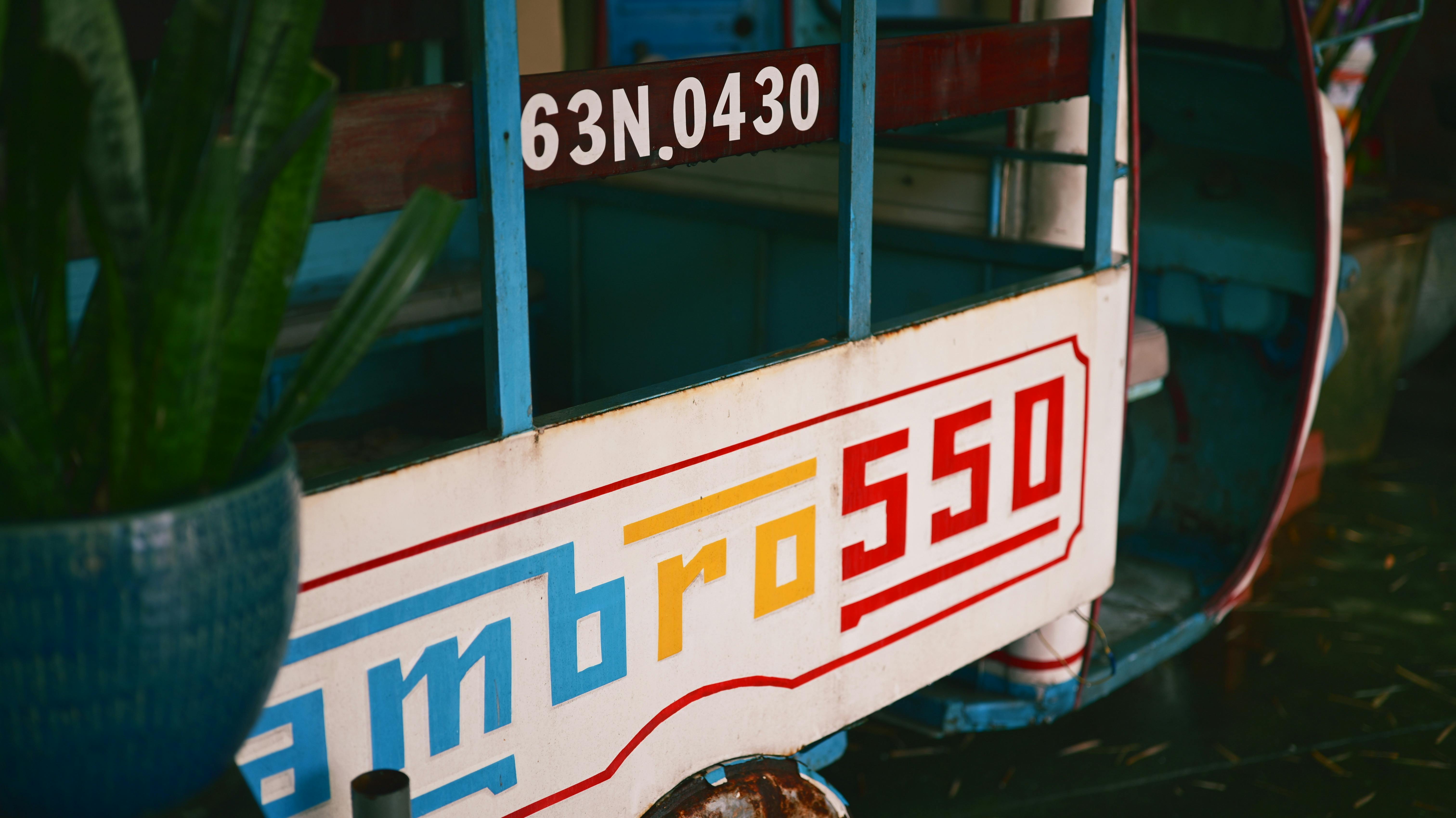 Free Close-up view of a vintage rickshaw with vivid colors and text details. Stock Photo