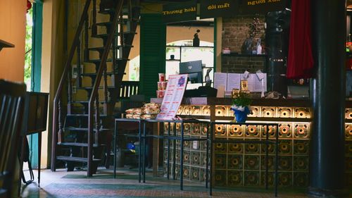 Free A warm and inviting cafe interior featuring a rustic staircase and illuminated counter. Stock Photo