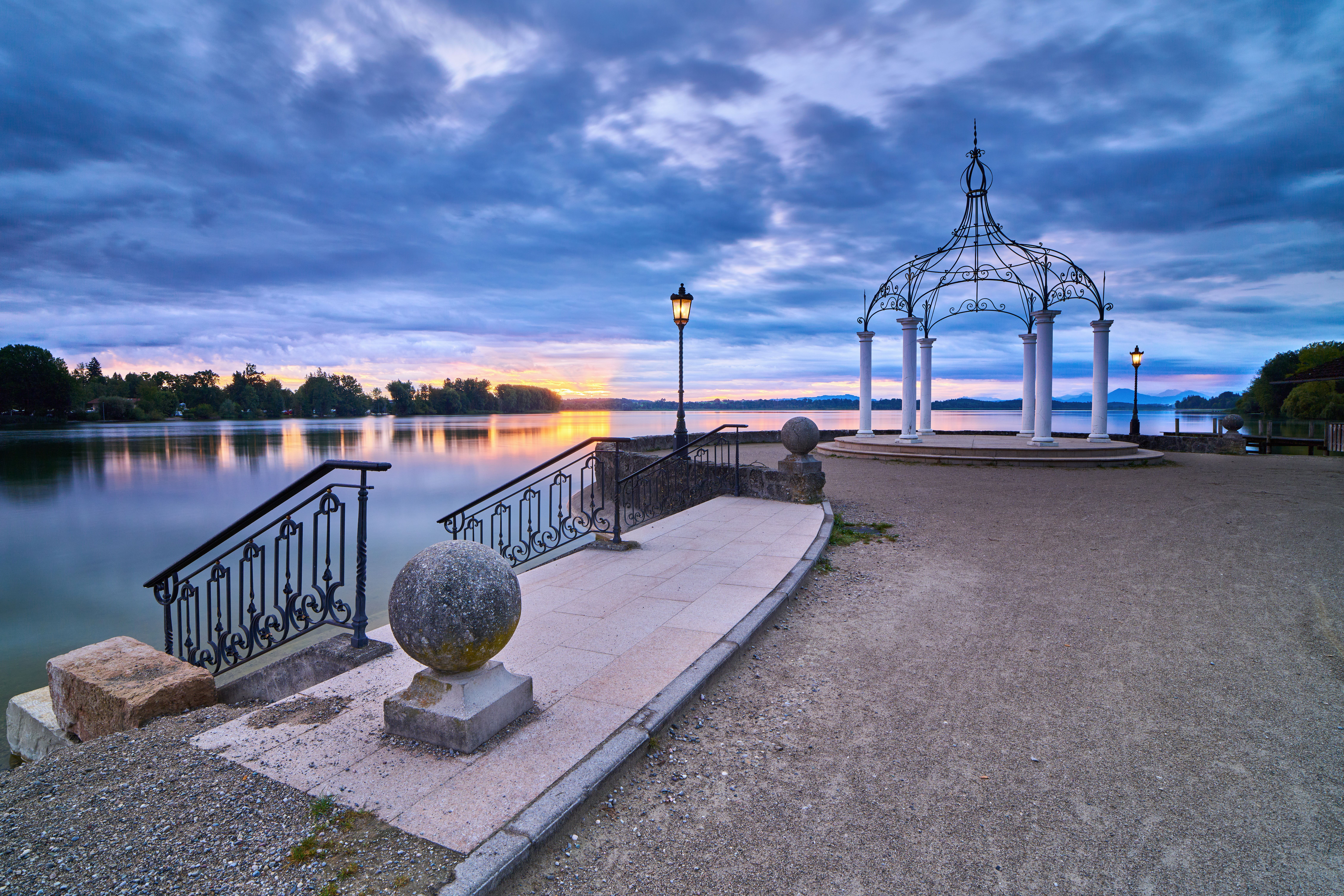 Scenic view of a lakeside pavilion at sunset on Waginger See, Bavaria, Germany.