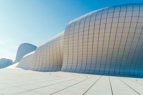 Free The Heydar Aliyev Center's modern architecture with sweeping curves under a clear blue sky in Baku. Stock Photo