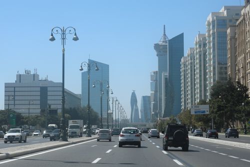 Free City skyline showcasing modern architecture and a busy urban street. Stock Photo