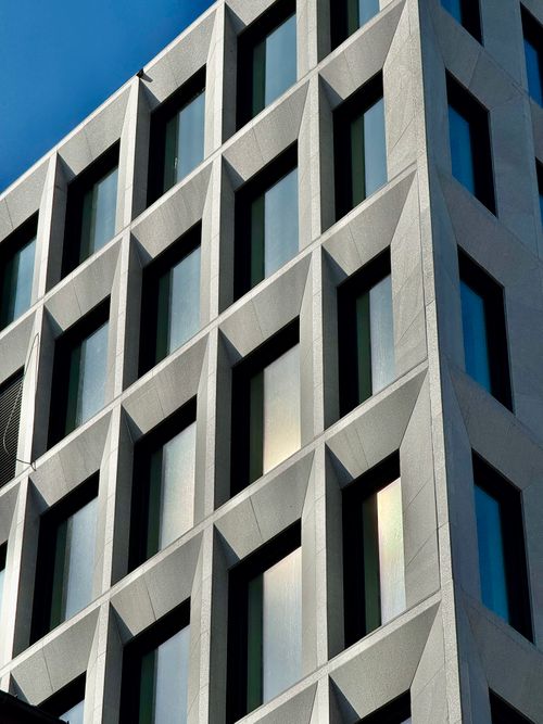 Free A striking modern building facade with geometric patterns and reflections in Oslo. Stock Photo