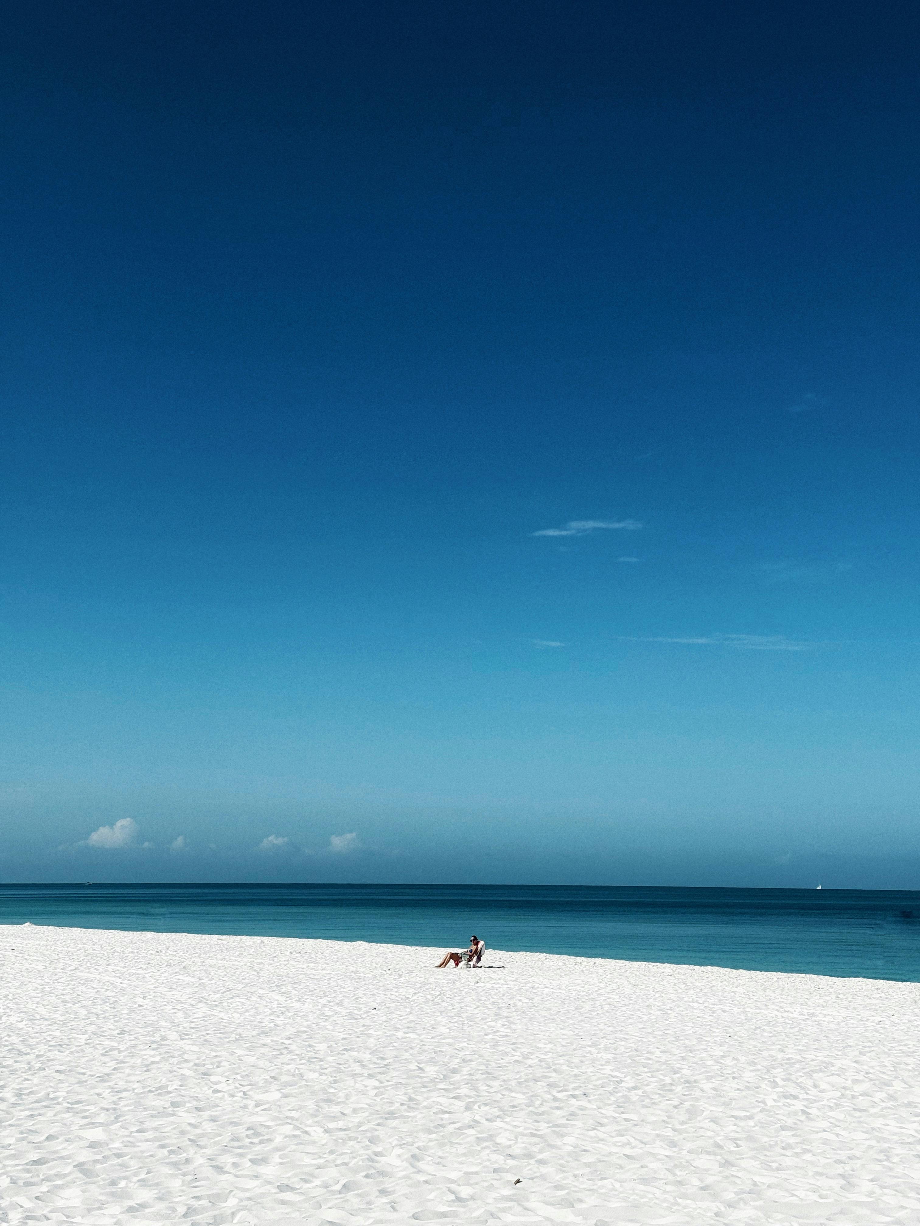 Peaceful beach scene with clear blue sky in Naples, Florida. Perfect for relaxation.