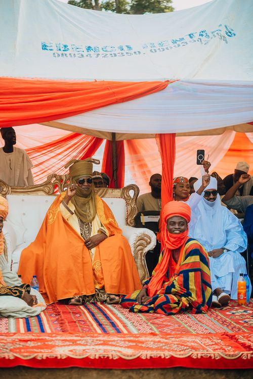 Free Vibrant cultural gathering featuring traditional attire and leaders in ceremonial setting. Stock Photo