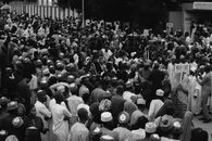 Monochrome image of a large crowd gathering outdoors in Niger State, Nigeria.