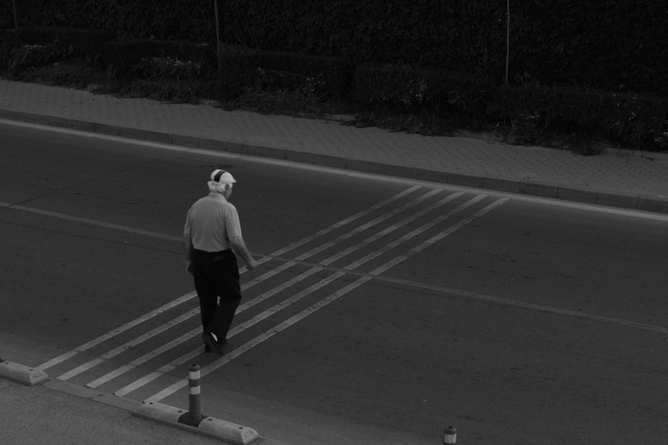Pedestrians carefully crossing a street in Yerevan, Armenia, with local traffic