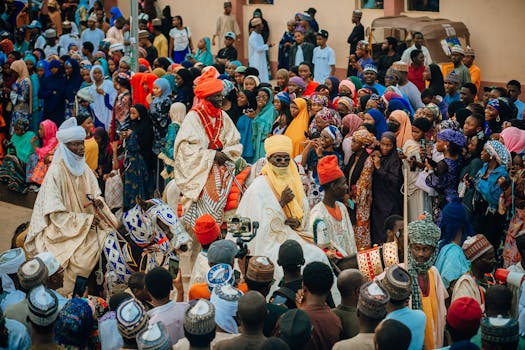 Colorful parade with people in traditional attire celebrating in Africa.