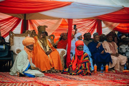 Free Vibrant cultural gathering with traditional garments and festive decor under canopy. Stock Photo