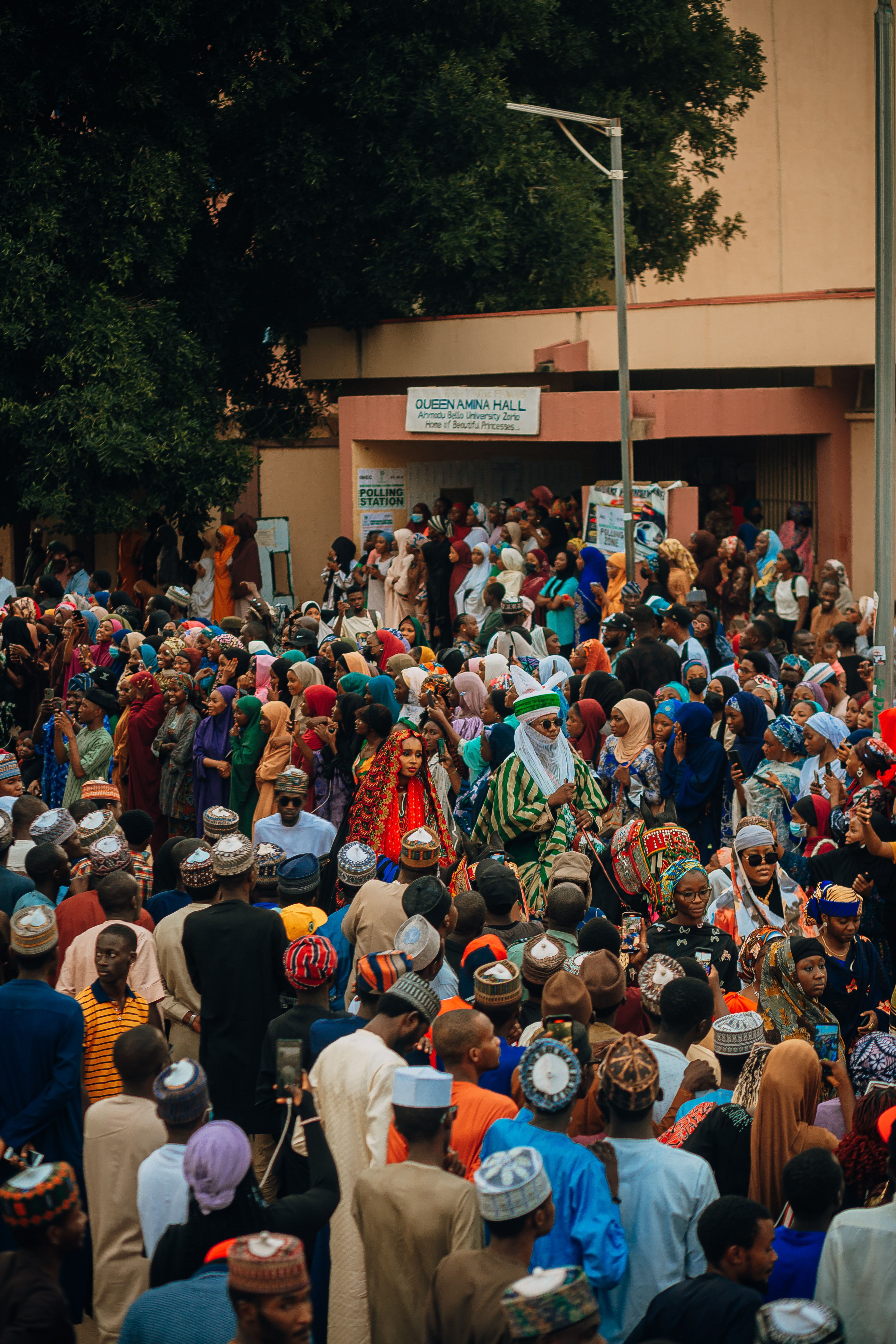 Vibrant gathering of diverse people at a cultural festival, rich in traditional attire.