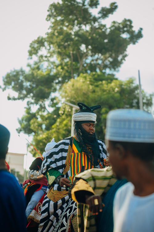 Free A traditional African parade featuring colorful attire and cultural costumes outdoors. Stock Photo
