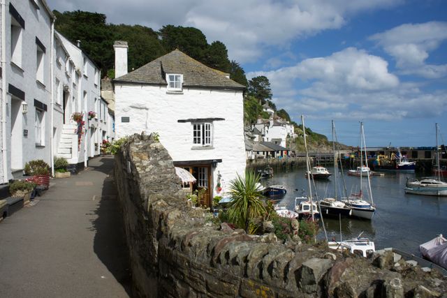 View of Polperro harbour in Cornwall with traditional coastal cottages historically used as furnished holiday lets