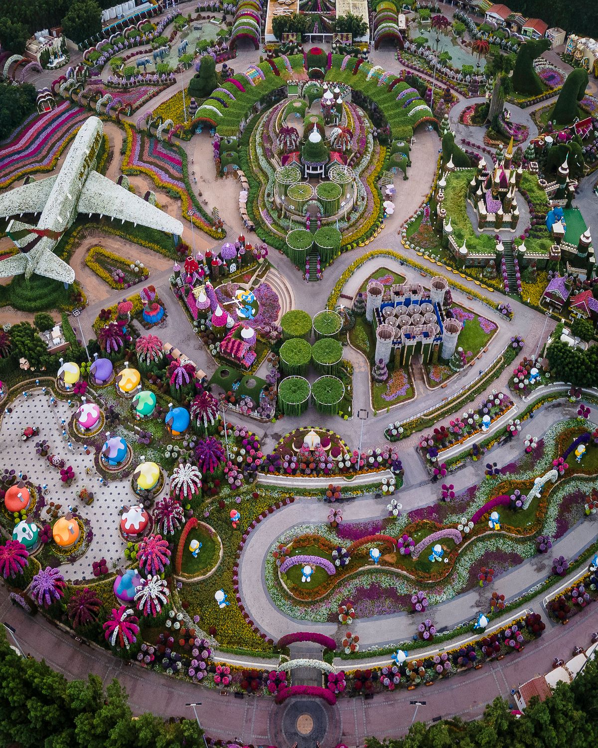 Aerial view of Dubai Miracle Garden: the flower-covered A380, curving flower beds, umbrella walkways and floral houses