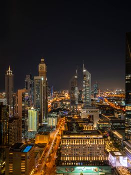 Breathtaking aerial view of Dubai's illuminated skyline at night, showcasing iconic towers and modern architecture.