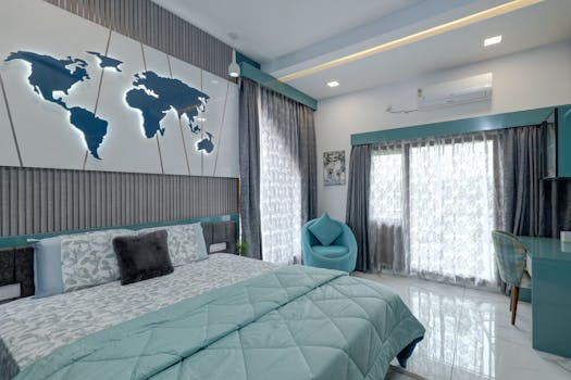 Stylish bedroom in Kochi with teal accents and world map decor.