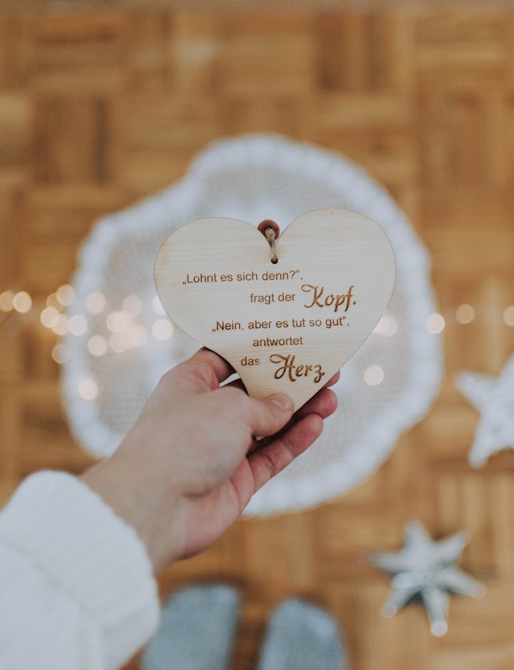 Person Holding White Heart Decor