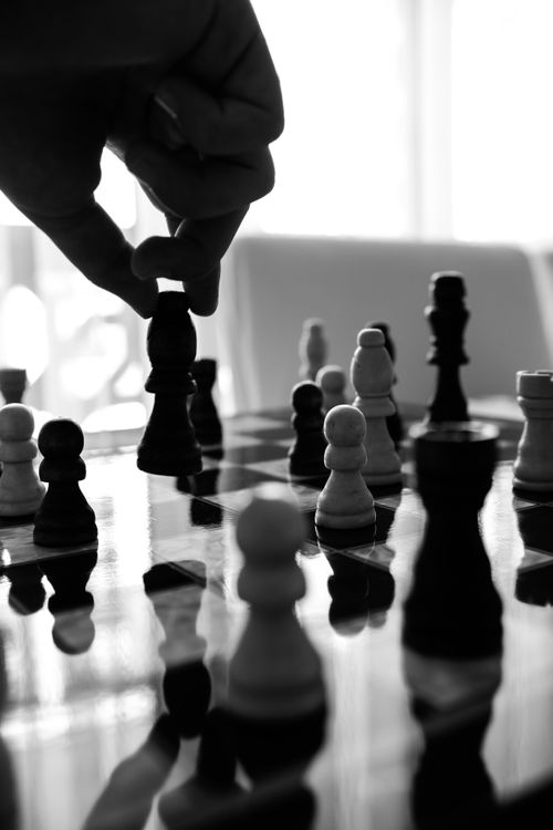 Free Monochrome image illustrating strategic chess moves on a reflective board. Stock Photo