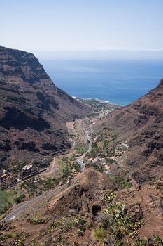 Stunning aerial view of Valle Gran Rey with dramatic cliffs and ocean horizon.