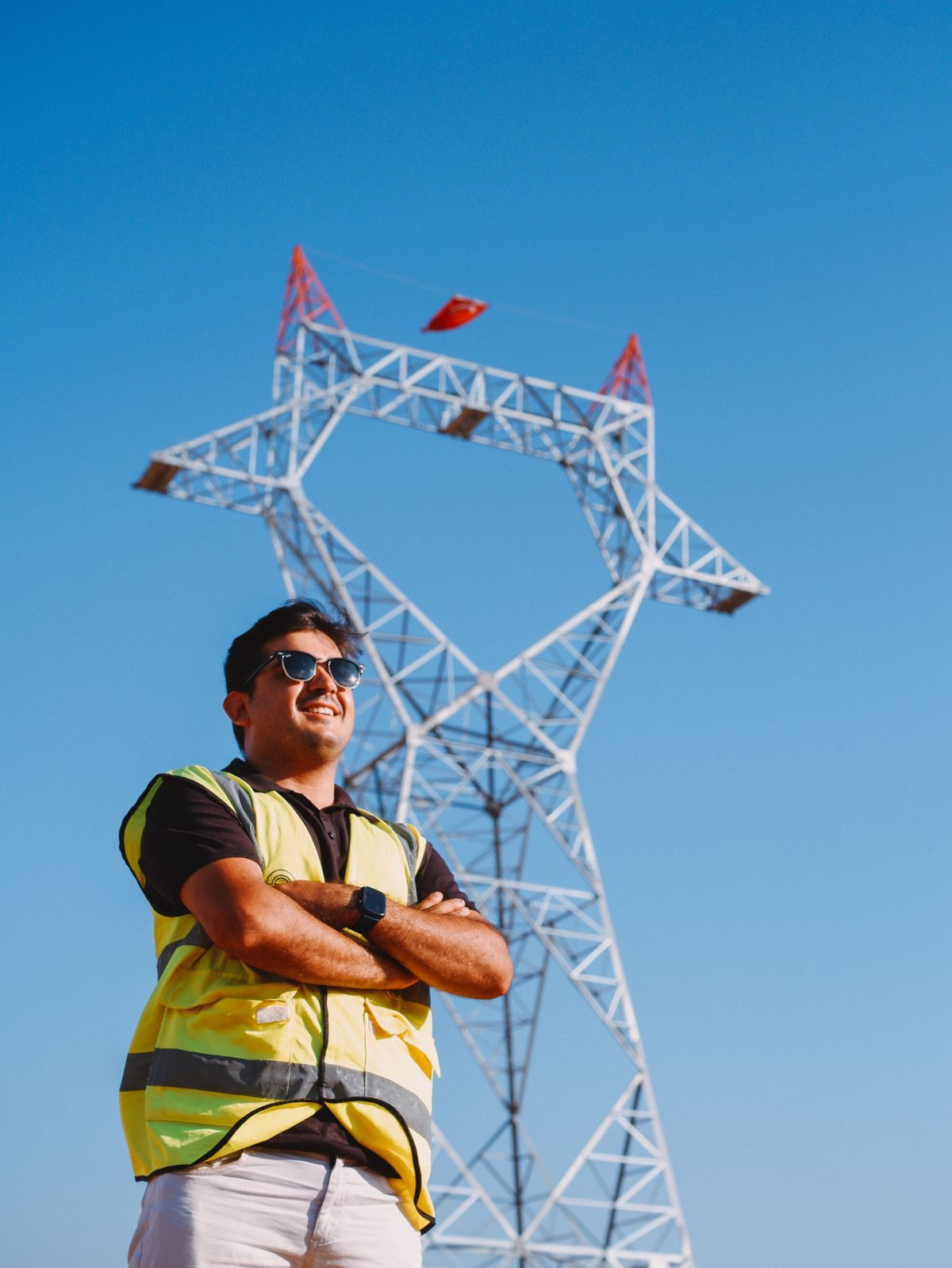 Engineer in safety gear inspecting high-voltage power infrastructure