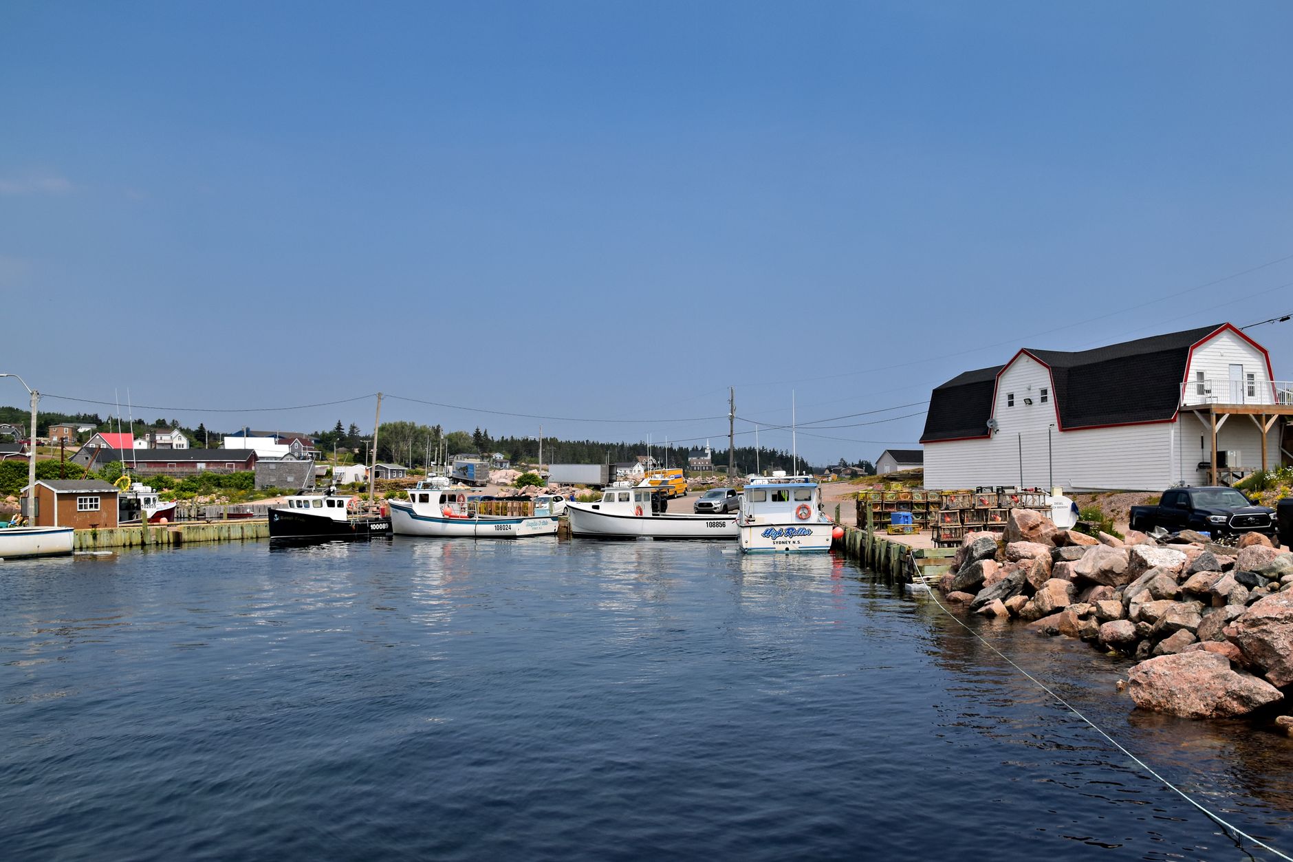 Peaceful harbor with fishing boats and coastal village scenery in Nova Scotia, Canada. โ photo by Jeffrey Eisen / Pexels