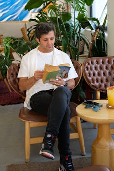 Man reading in a cozy Istanbul cafe with vibrant decor and plants.