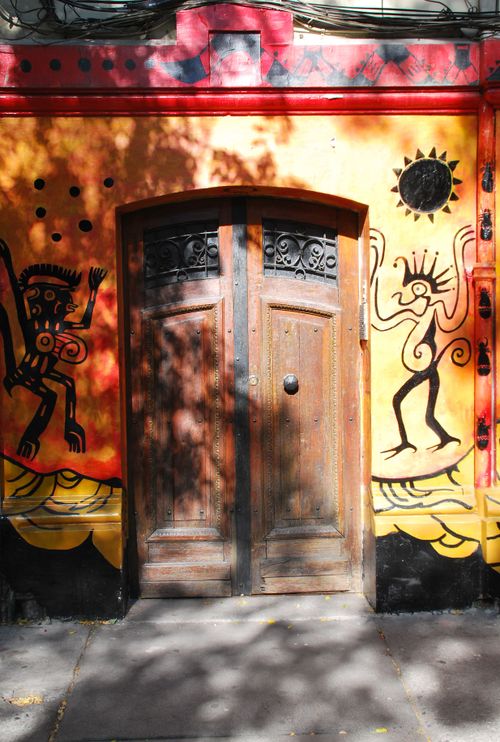 Free Vibrant mural with abstract figures on a door in Santiago de Chile, capturing urban art culture. Stock Photo