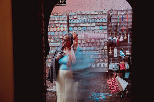 A vibrant street market with a person browsing colorful souvenirs. Perfect urban lifestyle photo.