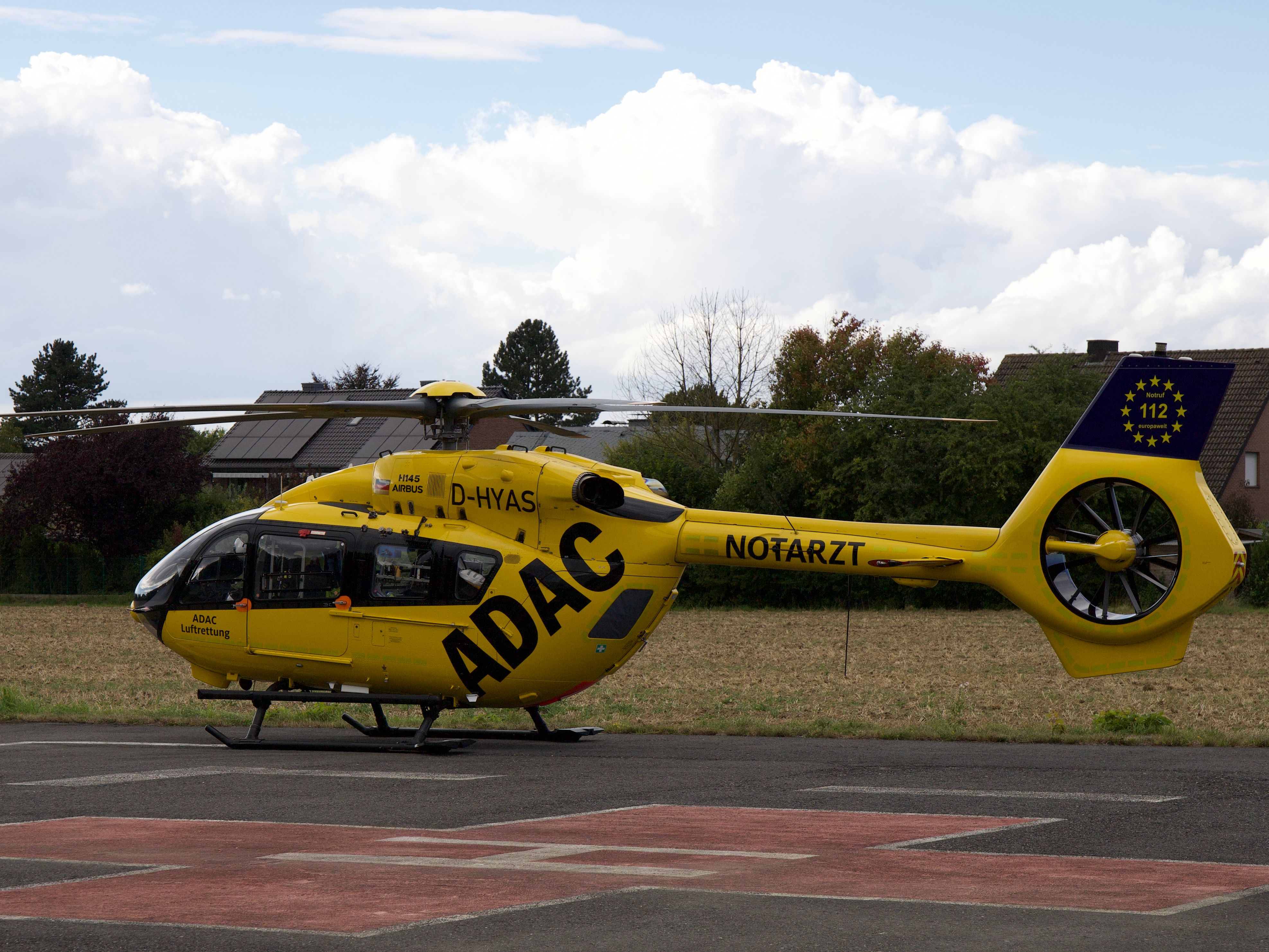 Yellow ADAC emergency helicopter parked outdoors in Soest, Germany.