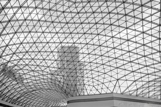 Black and white photo of a modern glass dome structure with geometric patterns.