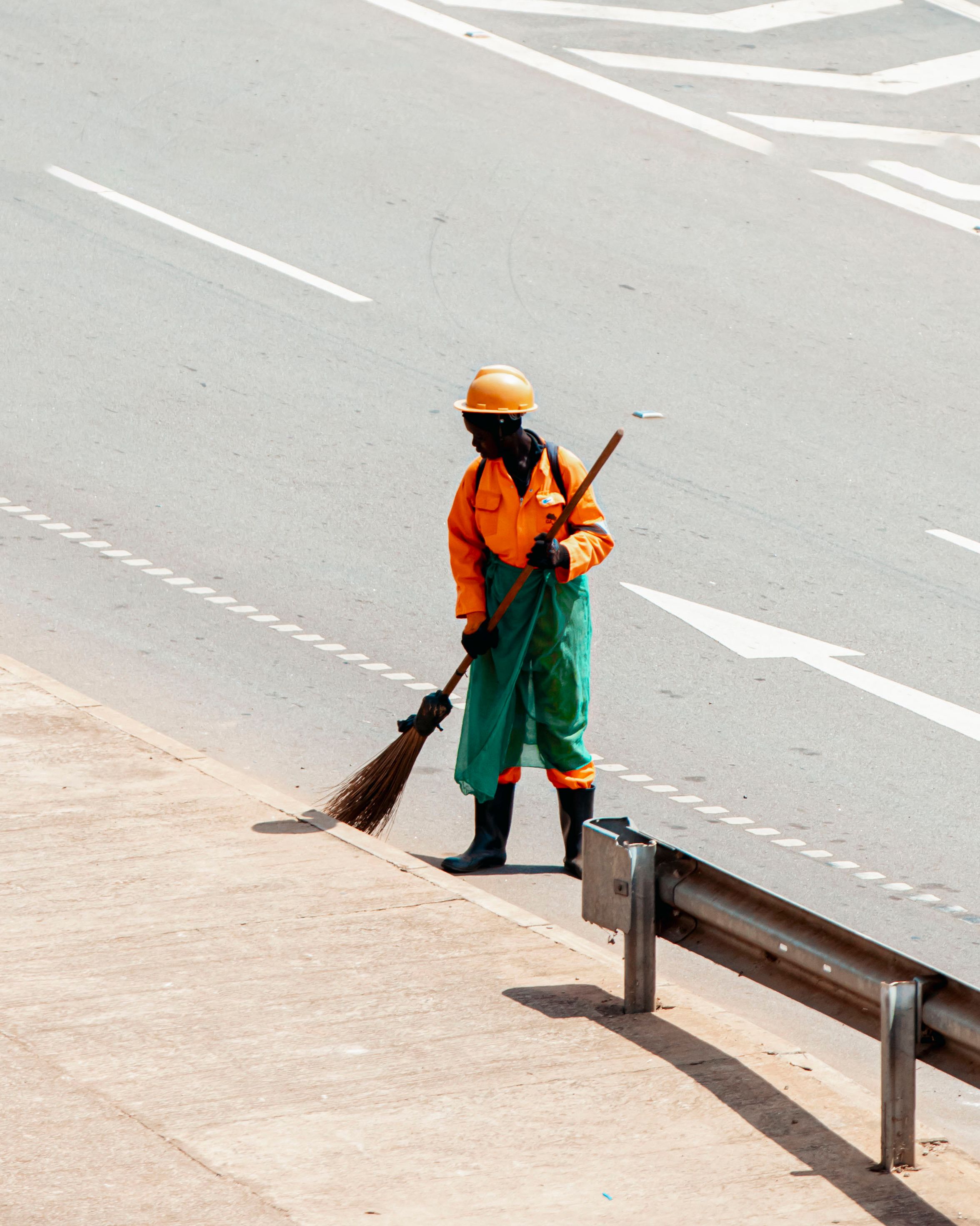 Street Cleaner Sweeping Sidewalk in Kampala, Uganda · Free Stock Photo