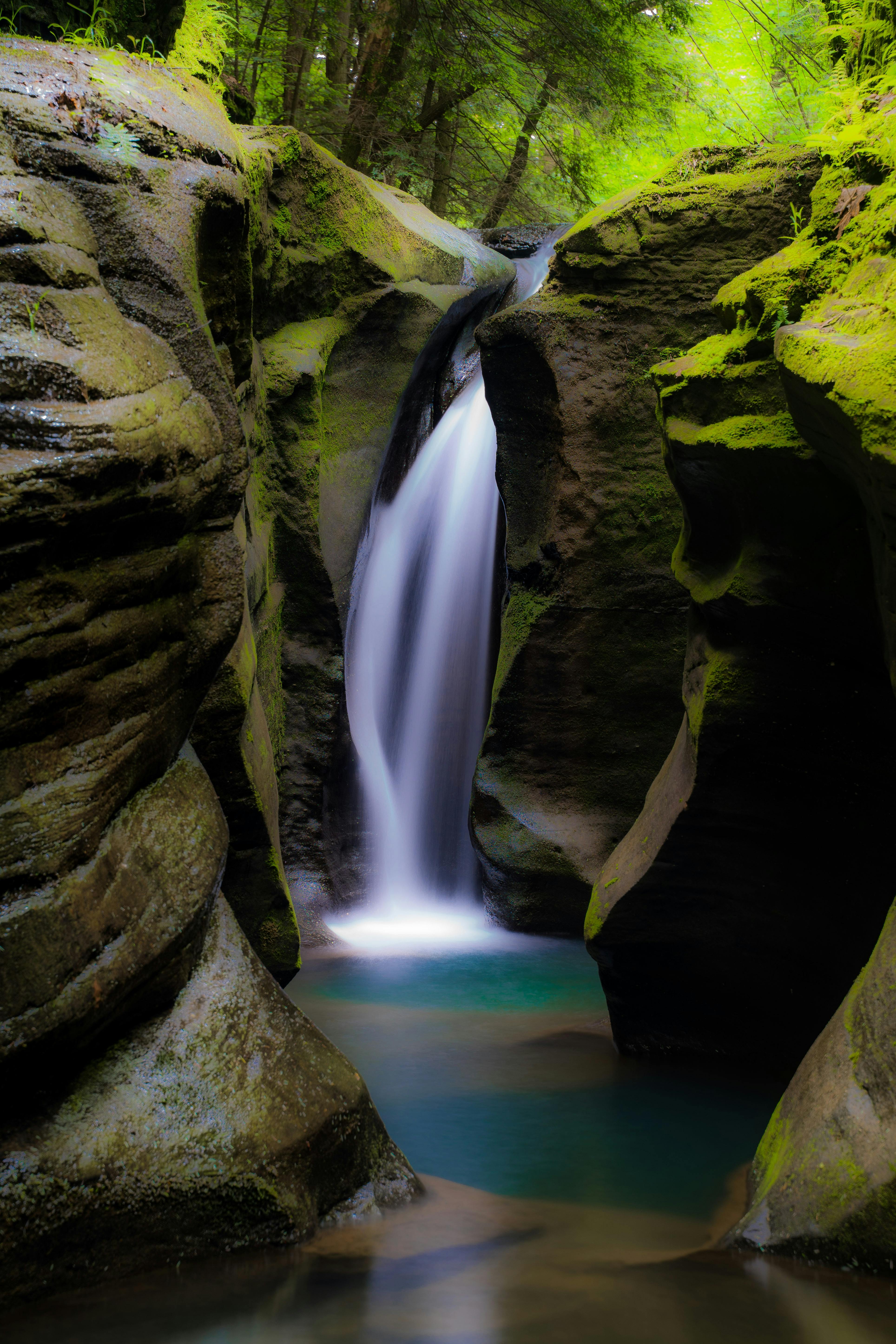 Amazing Waterfall Flowing Through Rocky Cliffs · Free Stock Photo