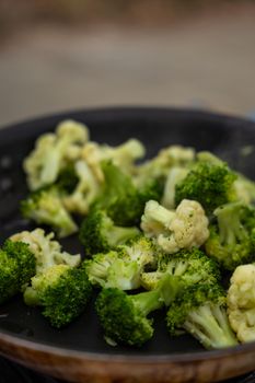 Close-up of fresh steamed broccoli florets in a pan, perfect for healthy eating themes.