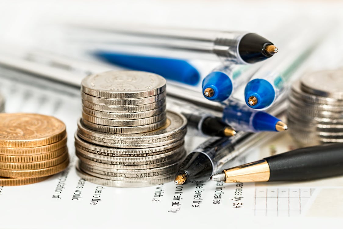 Coins Beside Ballpens