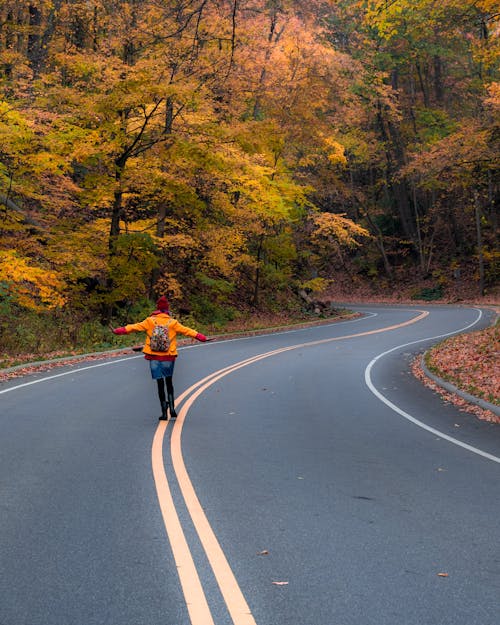 Woman Walking in Middle of Road