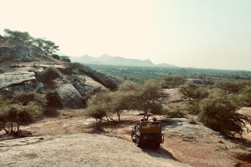 Free Explore the rugged terrain with a safari vehicle in this breathtaking natural landscape. Stock Photo